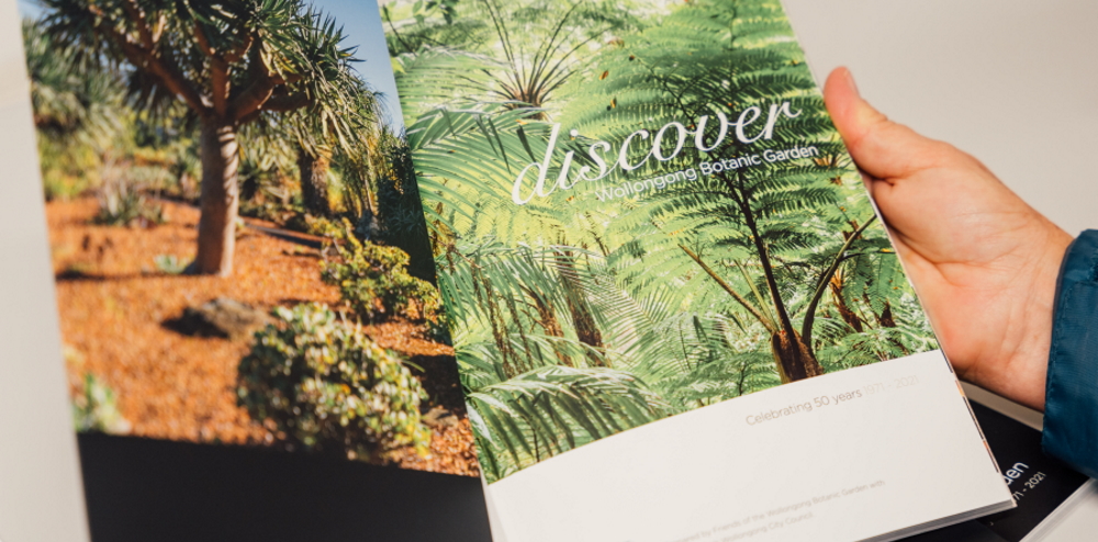 Person holding the Discover Wollongong Botanic Garden Book